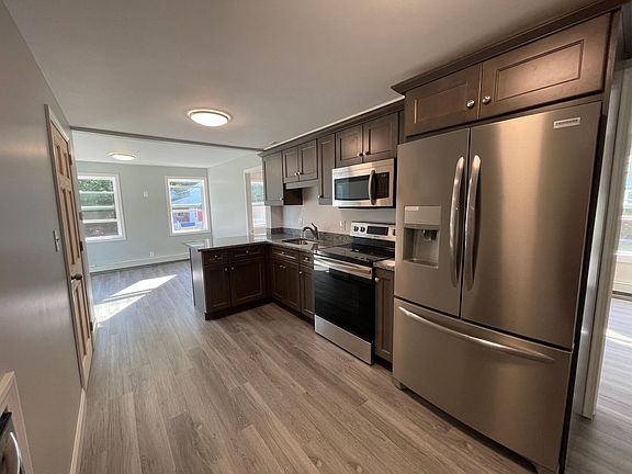 Spacious new kitchen flows into the dining area filled with natural light.