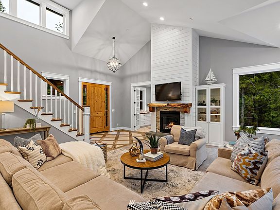 Artistic craftsman touches, such as the raw edged mantel which was created from lumber found on site, embellish the home with unique character and charm.