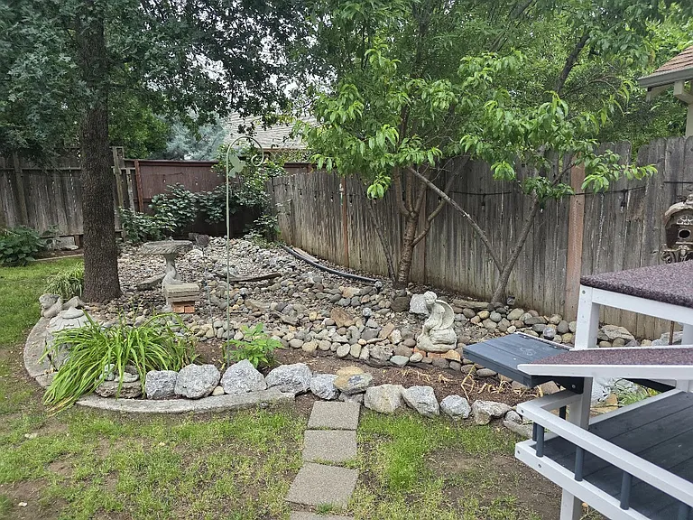 Spacious back yard area with Chinese Rock and Vegetable Garden.