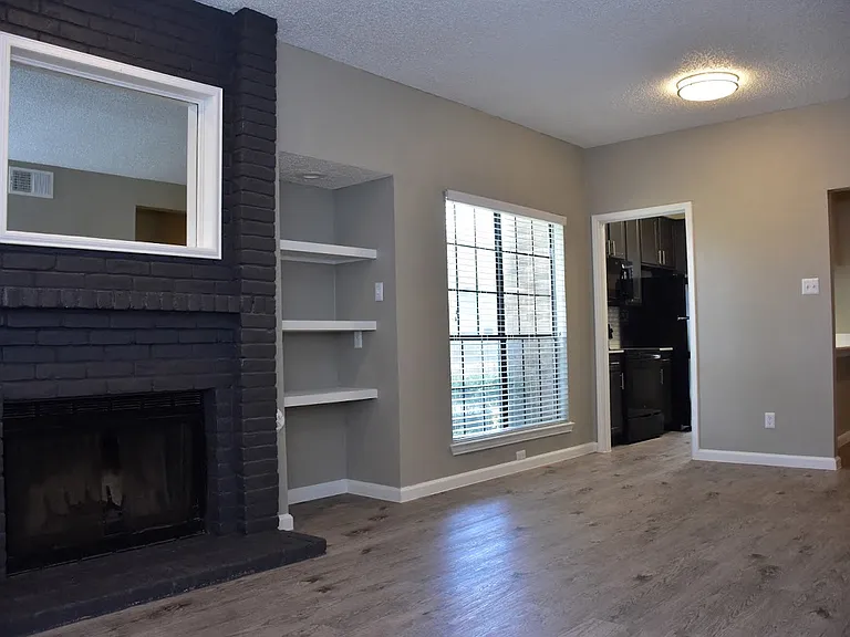 Oakwood Creek Apartments living area with fireplace and shelving