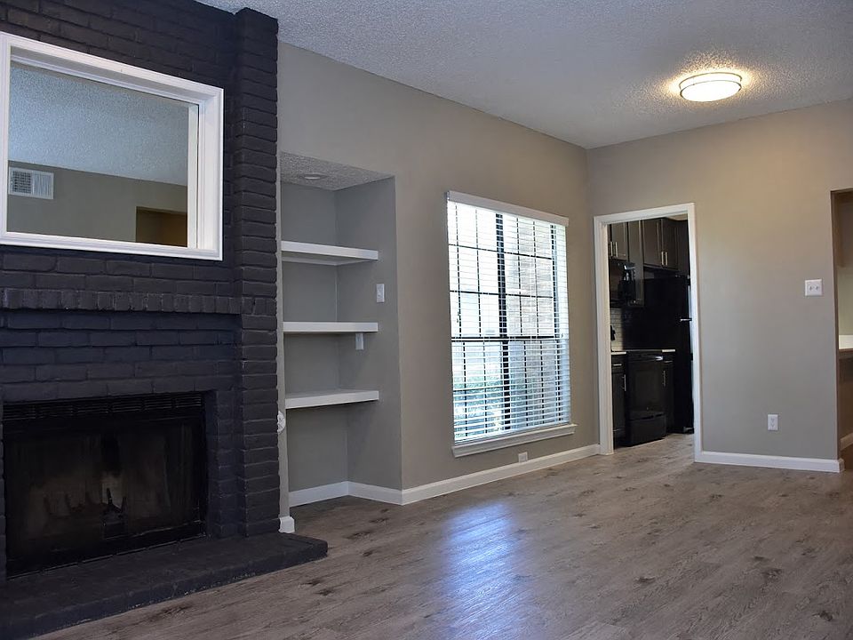 Oakwood Creek Apartments living area with fireplace and shelving