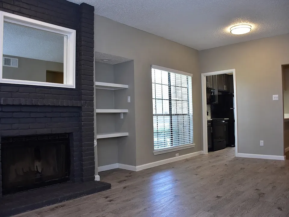 Oakwood Creek Apartments living area with fireplace and shelving