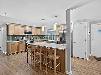 The inviting open floor plan creates a comfortable flow throughout the home, while the wood-burning — Photo 3