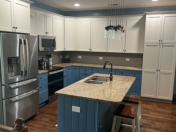 Kitchen with island and bar seating.