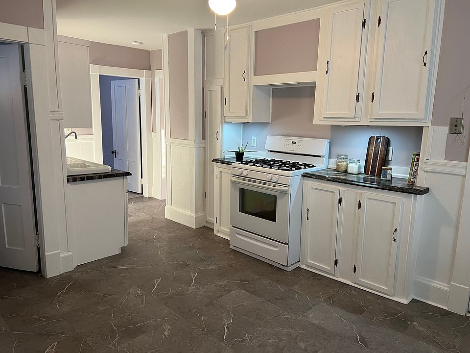 Large eat-in kitchen with gas stove, refrigerator, and pantry.