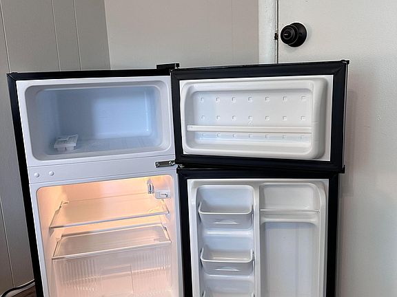 Refrigerator with freezer for fresh food & cold drinks.