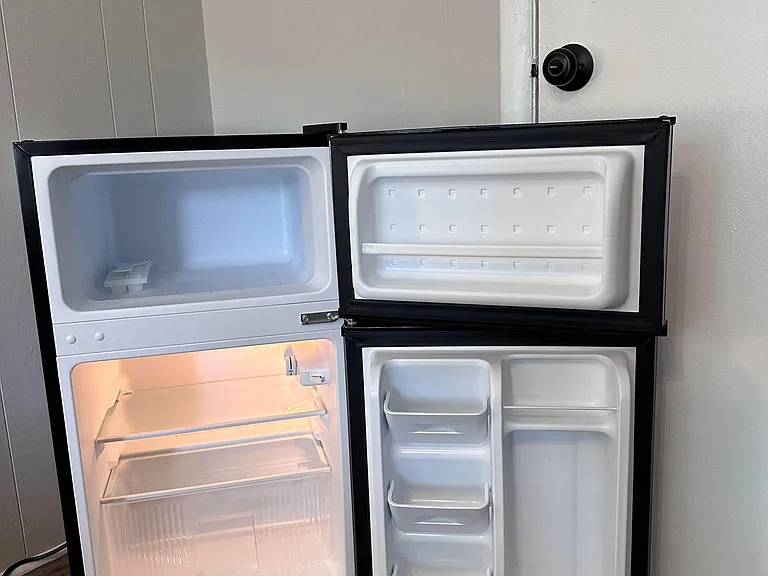 Refrigerator with freezer for fresh food & cold drinks.