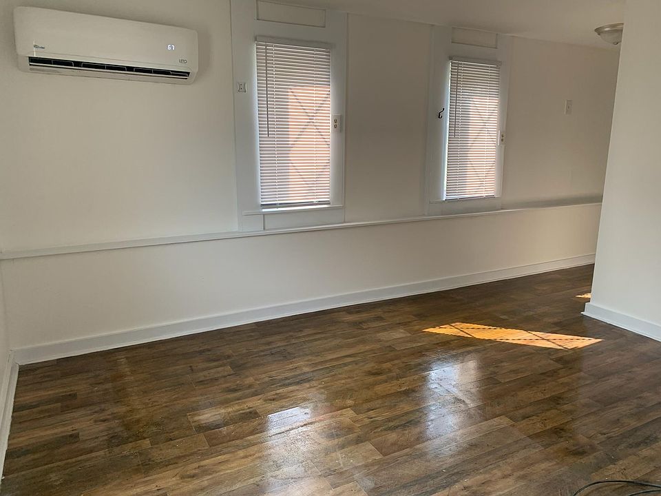 Another view of the living room space, full of natural light
