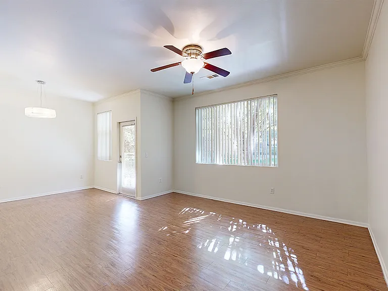 Apartment living and dining room with wood-style flooring.