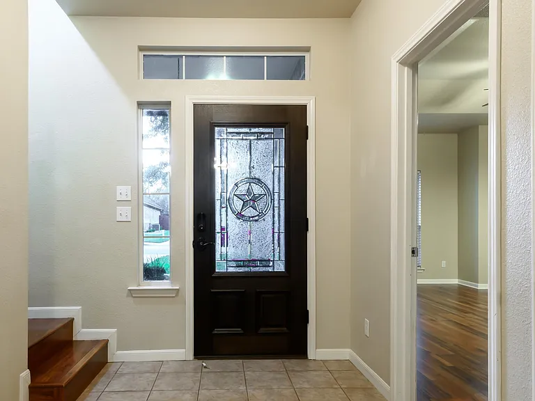 Foyer leads to the master bedroom on one side and the bonus room upstairs on the other.