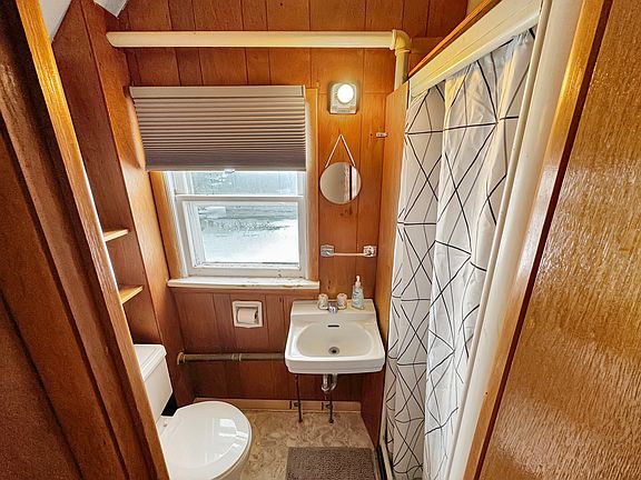 Small bathroom with shower. Black out blinds.
