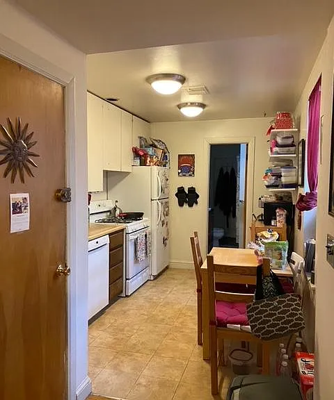 KITCHEN, APARTMENT DOOR FROM THE HALLWAY ON THE LEFT.LARGE WINDOW IN KITCHEN