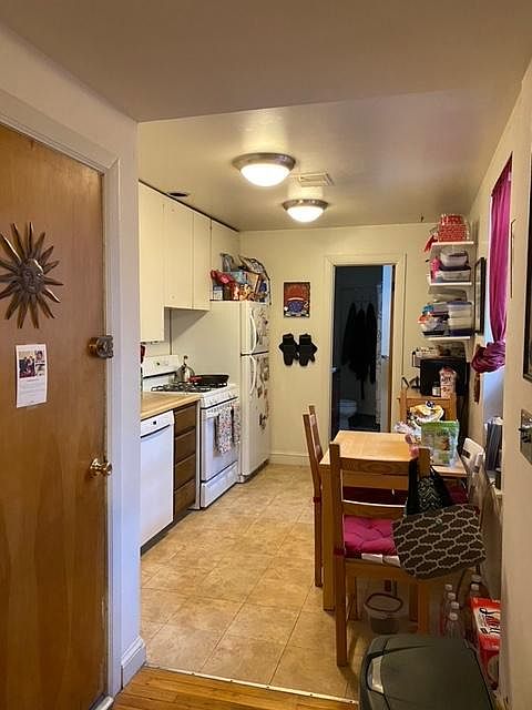 KITCHEN, APARTMENT DOOR FROM THE HALLWAY ON THE LEFT.LARGE WINDOW IN KITCHEN