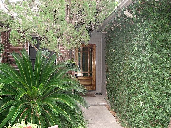 Inviting front porch with beautiful landscaping.