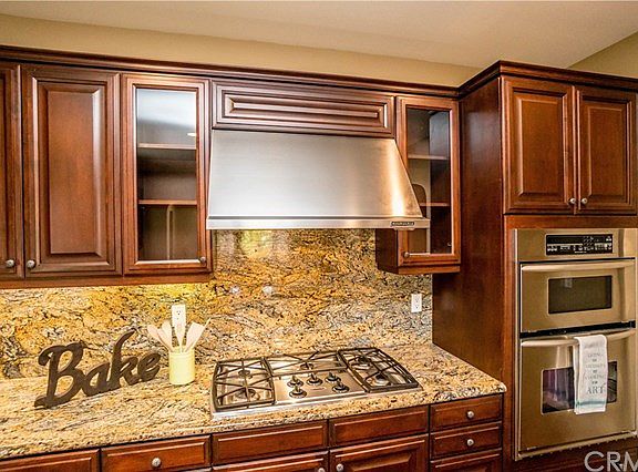 Kitchen with built in range, range hood and double oven