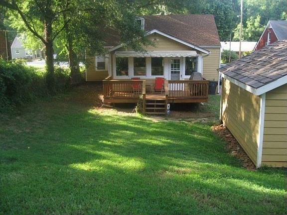 Deck adjoins sunroom for walkout access to yard