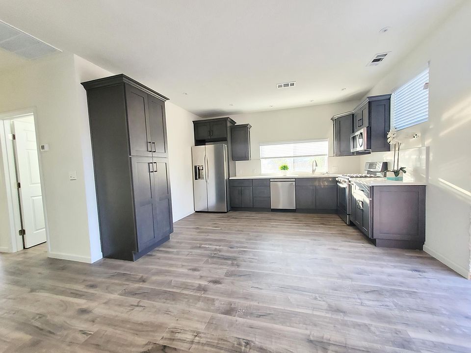 Newly built detached home about 1 year old. LUXURY plank flooring throughout. Spacious kitchen opens to living and dining area. View of sunset from kitchen. Lots of natural light throughout home.