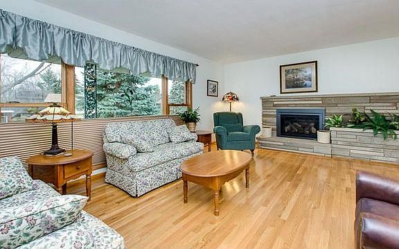 Spacious, bright living room with hardwood floors. Through out the home all new Anderson windows!
