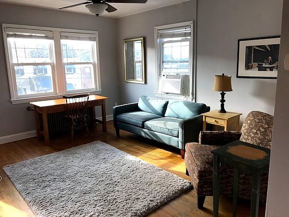 Living room for upstairs, unit #3. Windows are south- and west-facing.