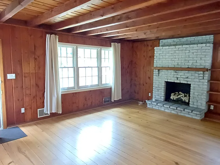 The gas fireplace sets a comfy tone whether on or off in the Williamsburg-style living area.