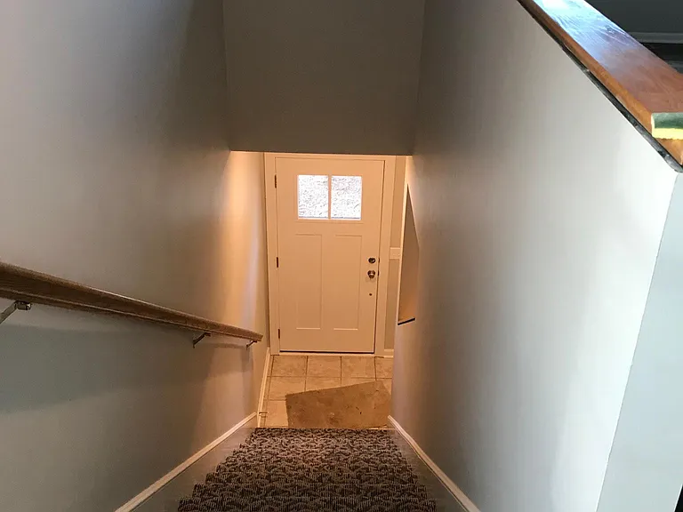 Stairs going down to front entry and garage access