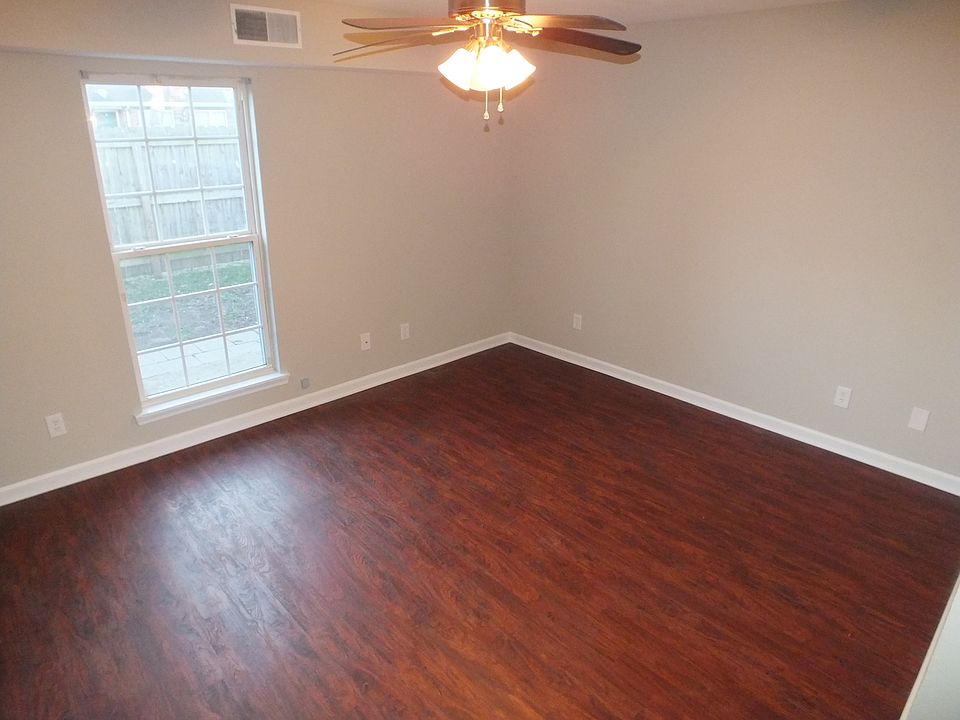 The living room has a ceiling fan.