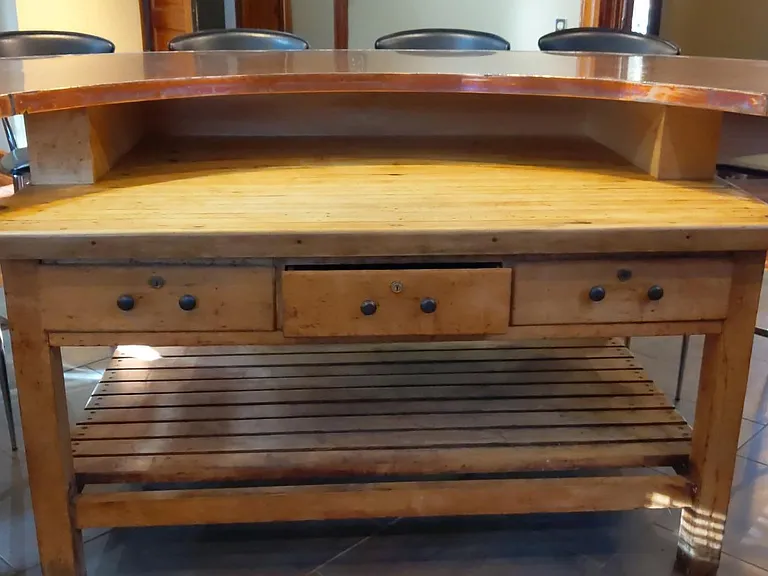 Vintage work table below the lovely copper bar