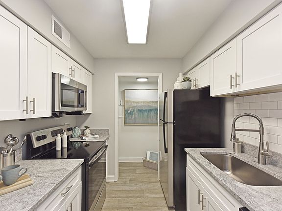 Kitchen with granite counters, stainless appliances, and modern cabinetry