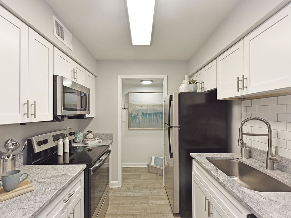 Kitchen with granite counters, stainless appliances, and modern cabinetry
