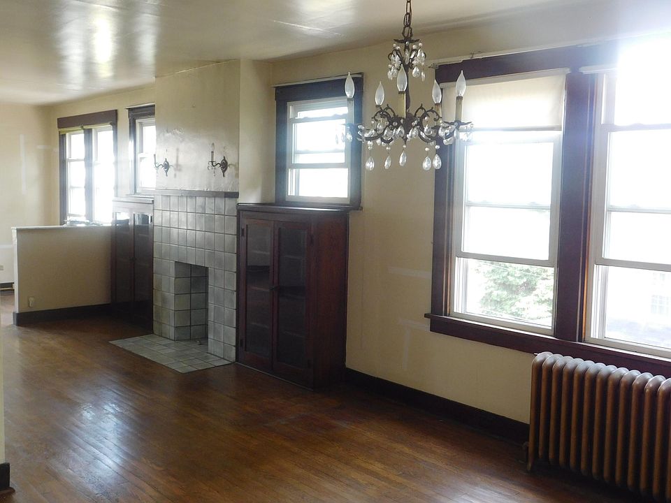 Dining room has a great chandelier and living room has a decorative fireplace with a mantle, sconces and built-ins.