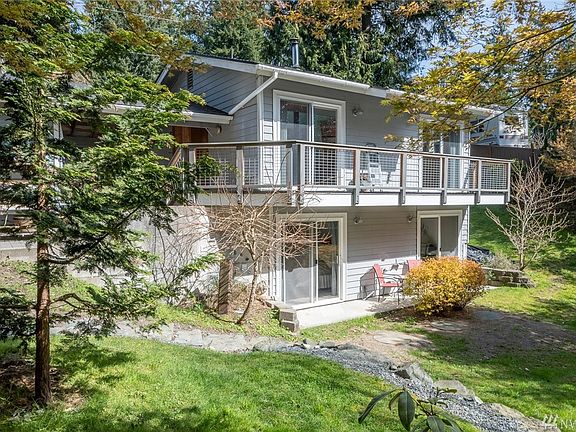 There is space for a little potting table and compost bin behind the carport.  From that concrete pad, there is a stone stair case that takes you down to the back yard.