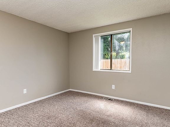 Bedroom with Light Brown Carpet and Large Window