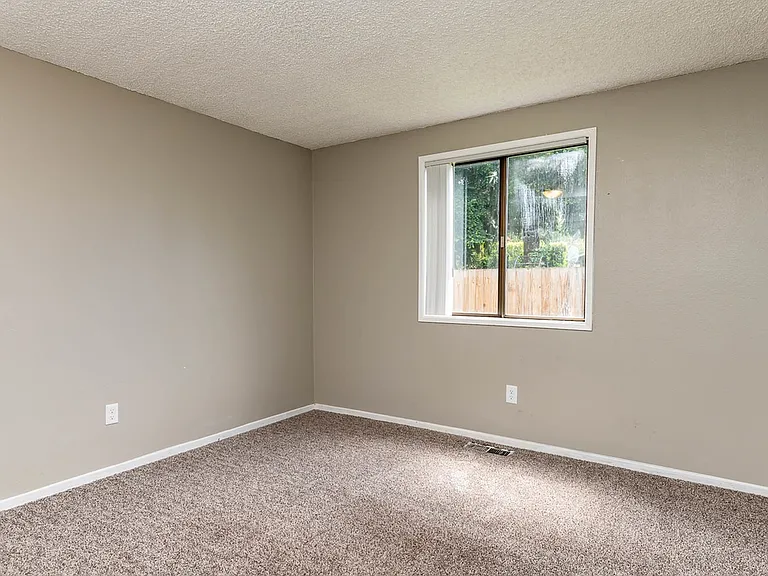 Bedroom with Light Brown Carpet and Large Window
