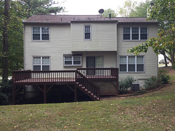 Large deck off kitchen; flat yard with wooded area