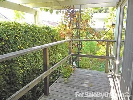 Living room.
						:
						New sliding glass door opens to new porch arbor. Shade tree cools living room.