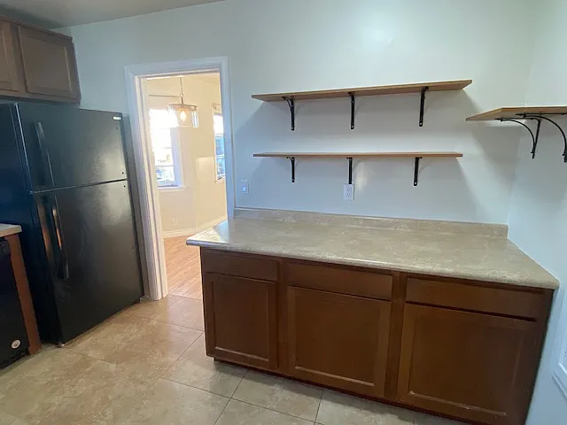 Kitchen with door leading to front room.