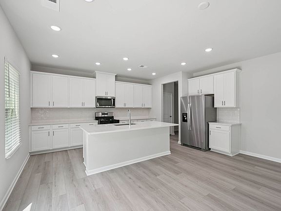 Kitchen in the Taylorsville floorplan at Cadence Meadows in Zebulon, NC.