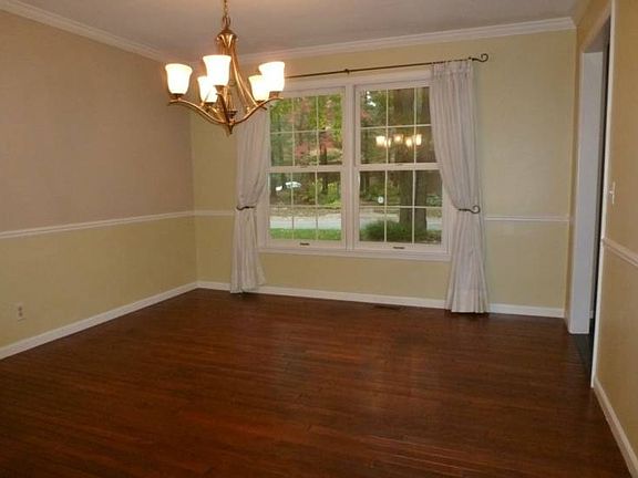 Steps from the kitchen is the formal dining room with crowned molding and hardwood floors!