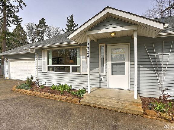 Down the hall, relax in the spacious master with an ensuite bath and large walk-in closet. You will also find one guest bedroom and full guest bath. The open-concept kitchen has been recently remodeled within the last 5 years. Extend your living space to the large backyard and covered patio.  Enjoy close proximity to both public & private schools. Ideal commuter location with easy access to freeways, light rail, SeaTac Airport, hospital, major retail, dining & business hubs. 