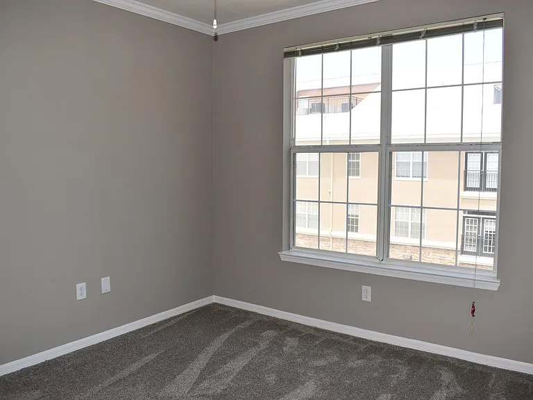 Second bedroom with pool view.