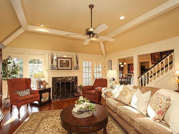 Large Living Room with gas log fireplace, high ceilings and hardwood floors.