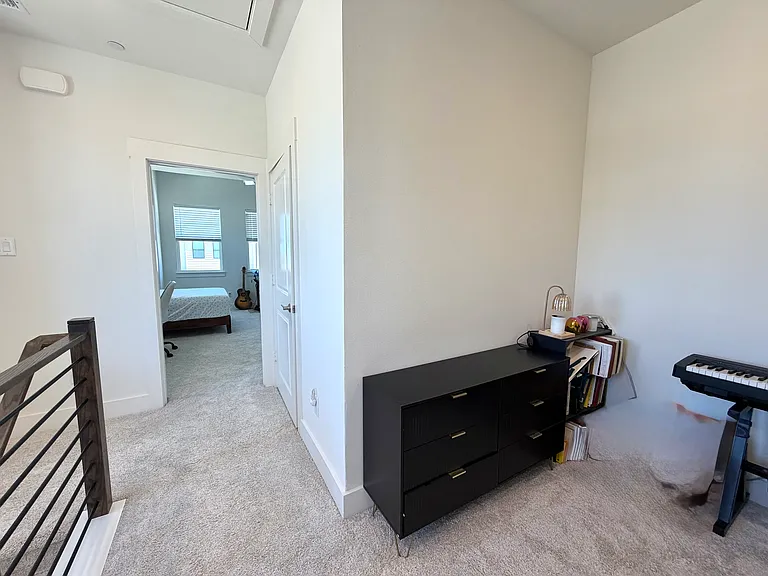 A flex room is located between the primary suite and the second bedroom, offering versatility as a home office or game room.