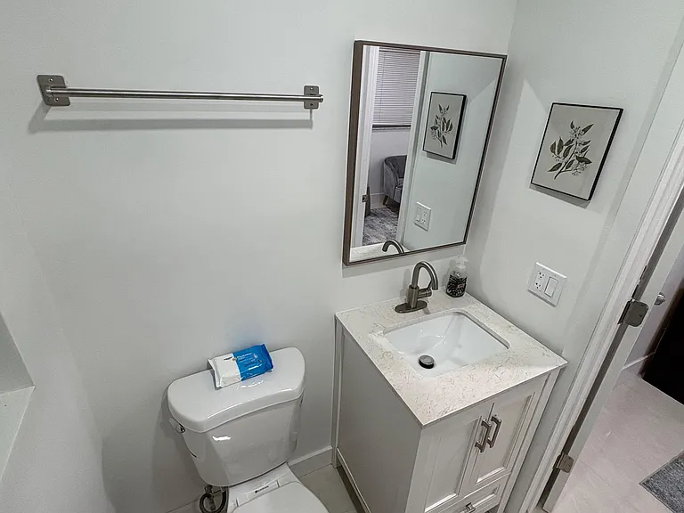Well-kept half bath with a vanity sink, framed mirror, and built-in cabinet storage for daily essentials.