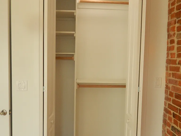 Large closet, with custom shelving.