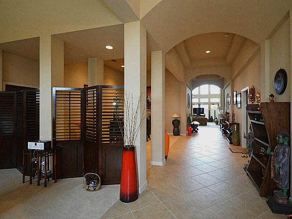 Tiled entry features beautiful arched walkways with high ceilings.