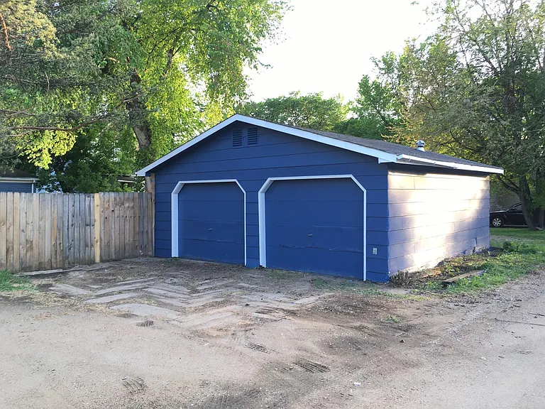 Oversized detached garage, drive in gate and additional parking off of alleyway.