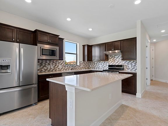 Stainless steel gas appliances and stylish backsplash in the kitchen