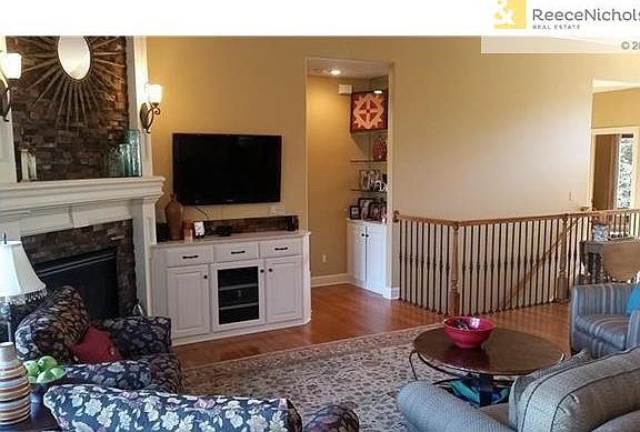 Beautiful hardwoods throughout; distinctive stacked stone fireplace; built-ins & crown molding