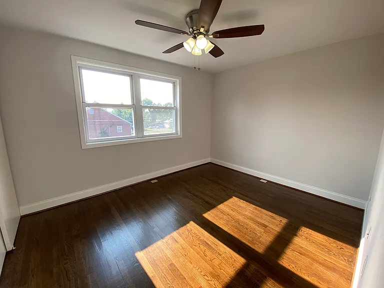 Rear bedroom #1 (largest upstairs) w/partial water views & ceiling fan