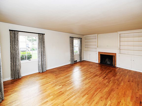 Living room, shelves, fireplace, windows with much light